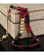 Red strained squeezing amber named rosary and note written wooden box