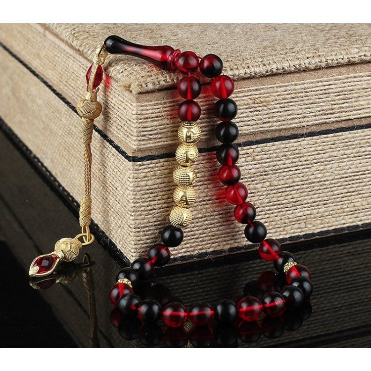 Red strained squeezing amber named rosary and note written wooden box