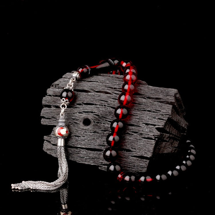 Gebetskette aus Feuerbernstein mit rot emaillierter Silberquaste